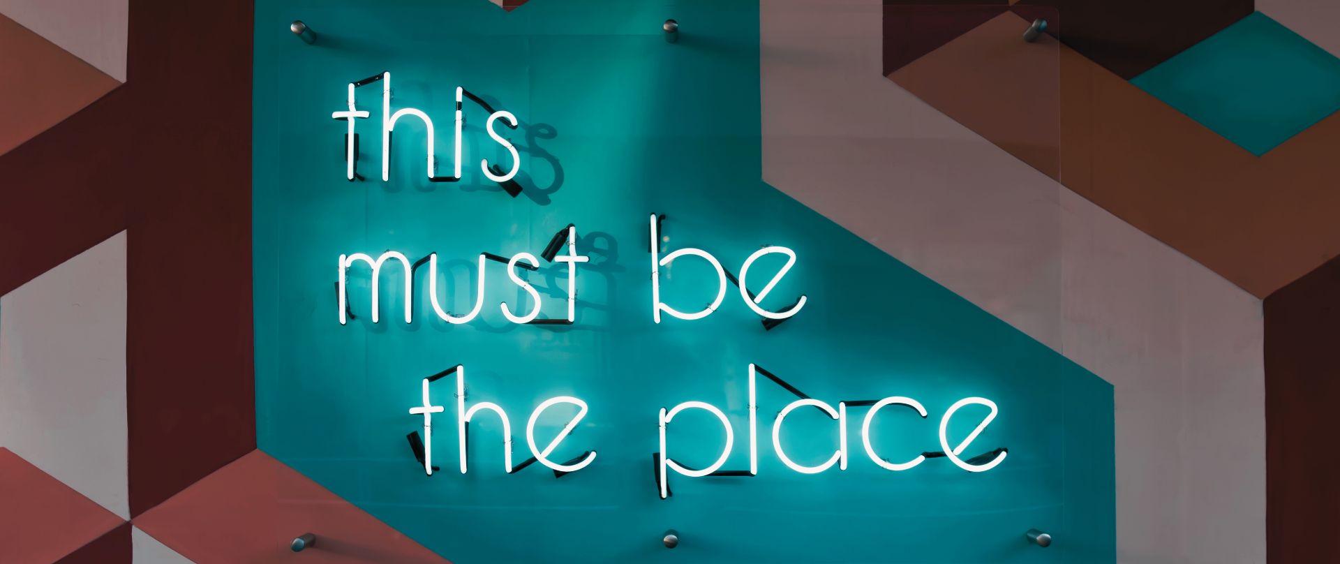 Neon sign that reads This Must Be The Place